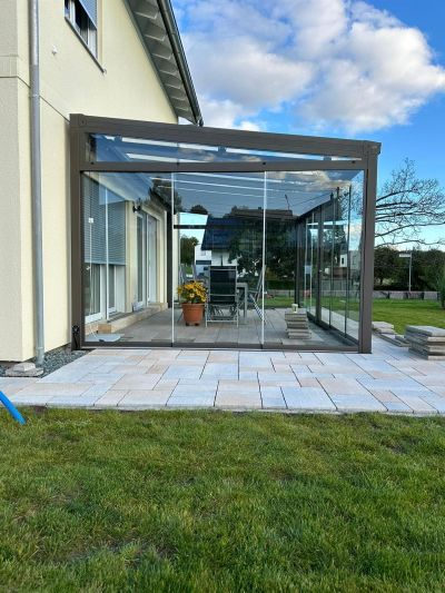 Überdachter Sitzplatz mit Glasflächen für Rundumschutz