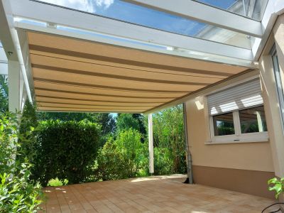 Terrassendach mit integrierter Unterdachmarkise bei Sonnenschein